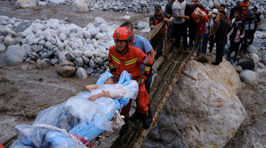 Chinese firefighters worked in treacherous terrain to help evacuate more than 11,000